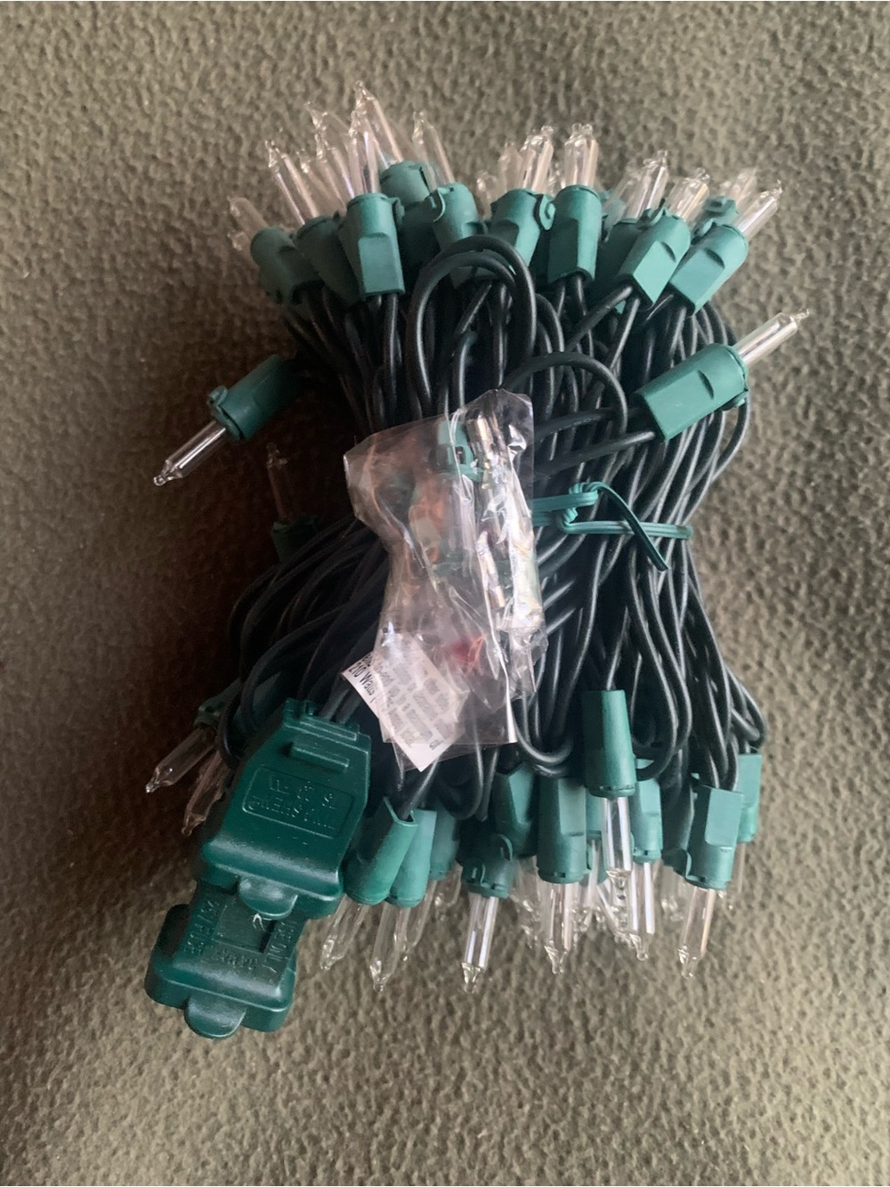 New clear mini incandescent string lights. Plug in. Green wire. Indoor.